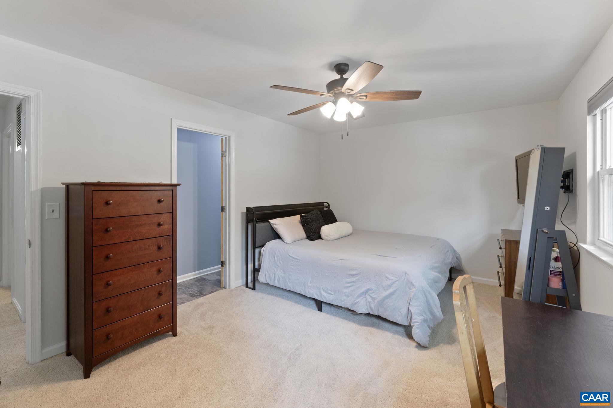 705 Prospect Avenue Charlottesville, VA 22903 - Photo 24 of 38 a bedroom with a bed and a chandelier