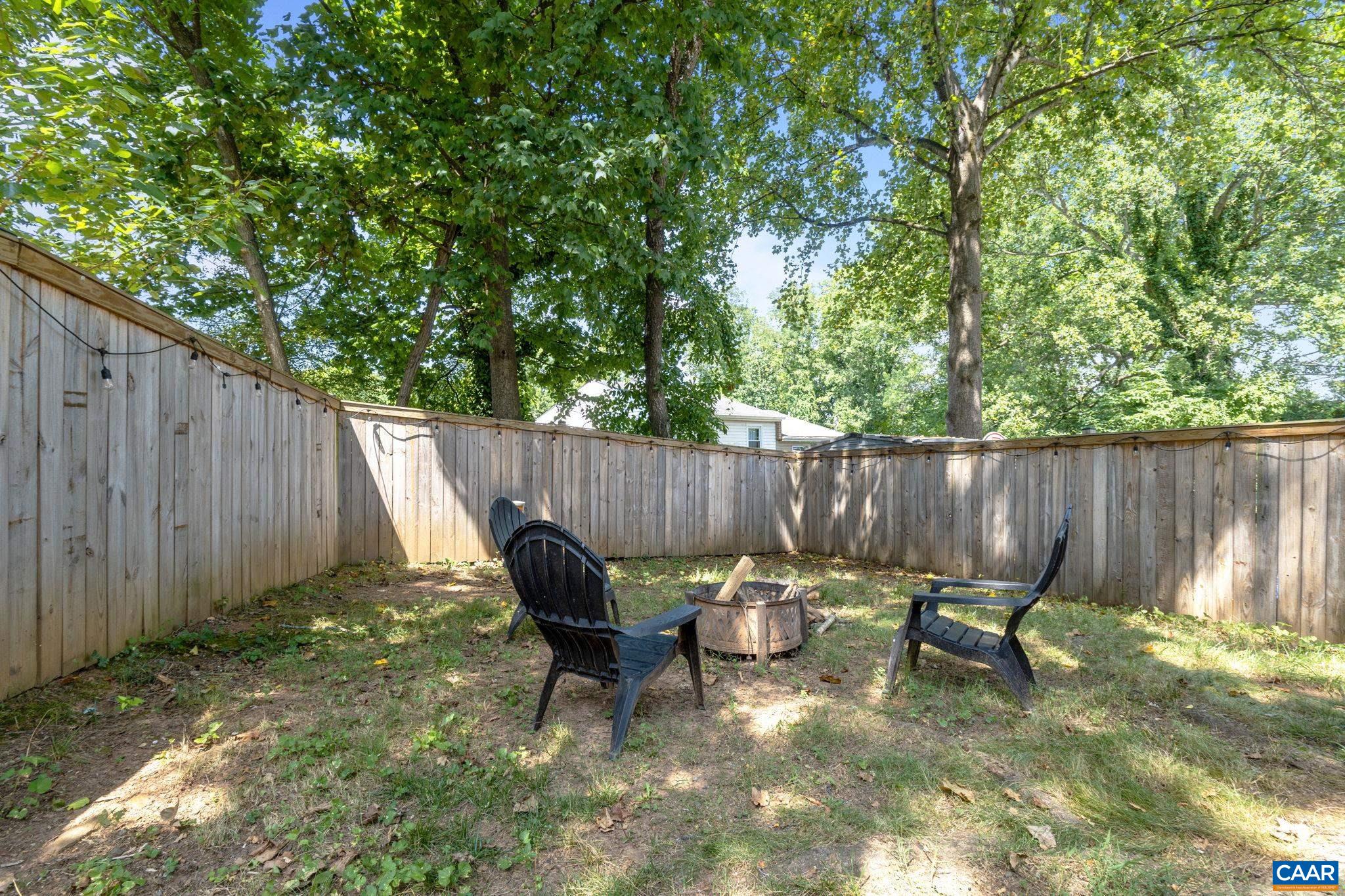705 Prospect Avenue Charlottesville, VA 22903 - Photo 26 of 38 a backyard of a house with lawn chairs and wooden fence