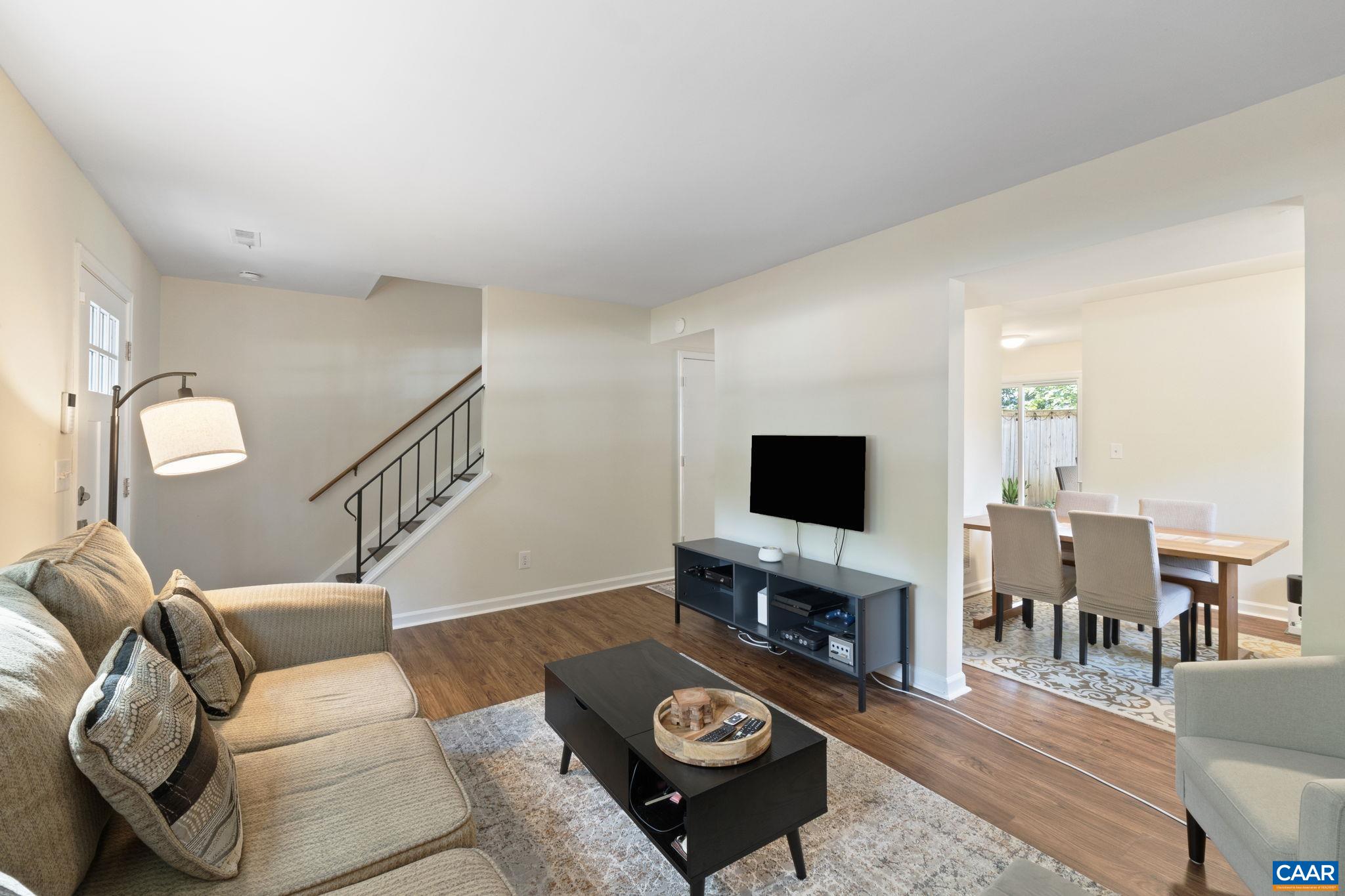 705 Prospect Avenue Charlottesville, VA 22903 - Photo 8 of 38 a living room with furniture a fireplace and a flat screen tv
