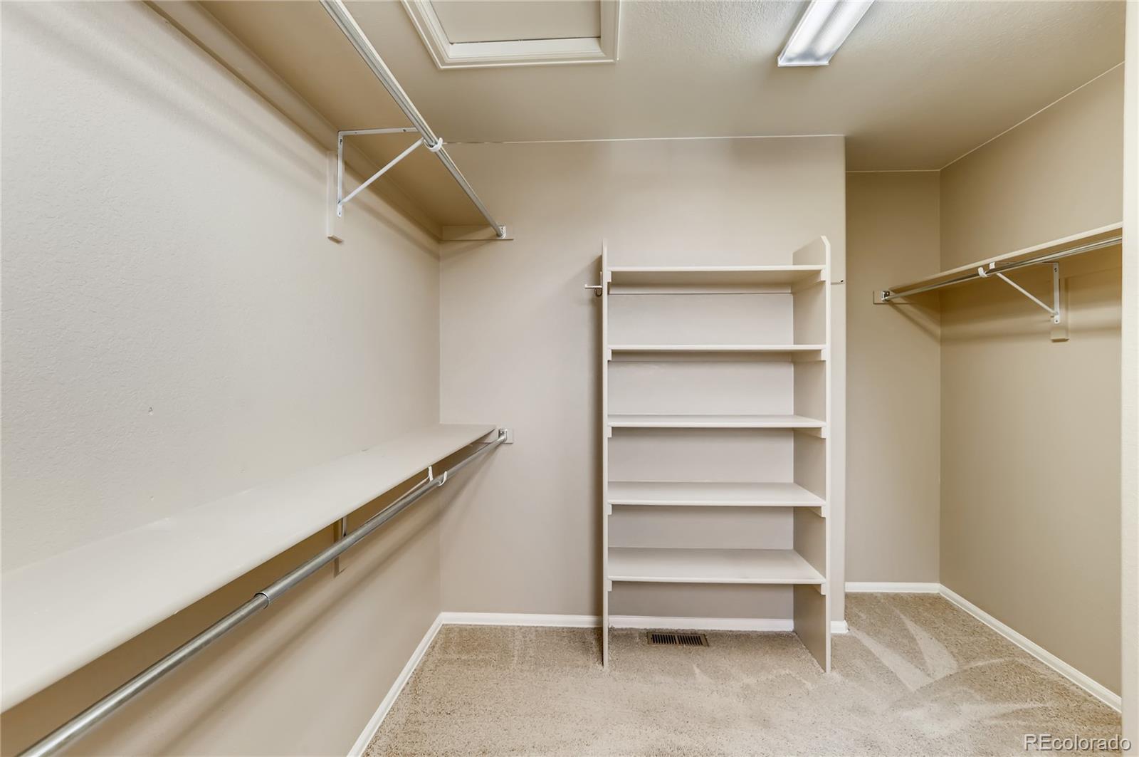 8627 Raspberry Drive Frederick, CO 80504 - Photo 23 of 33 a view of walk in closet with empty racks
