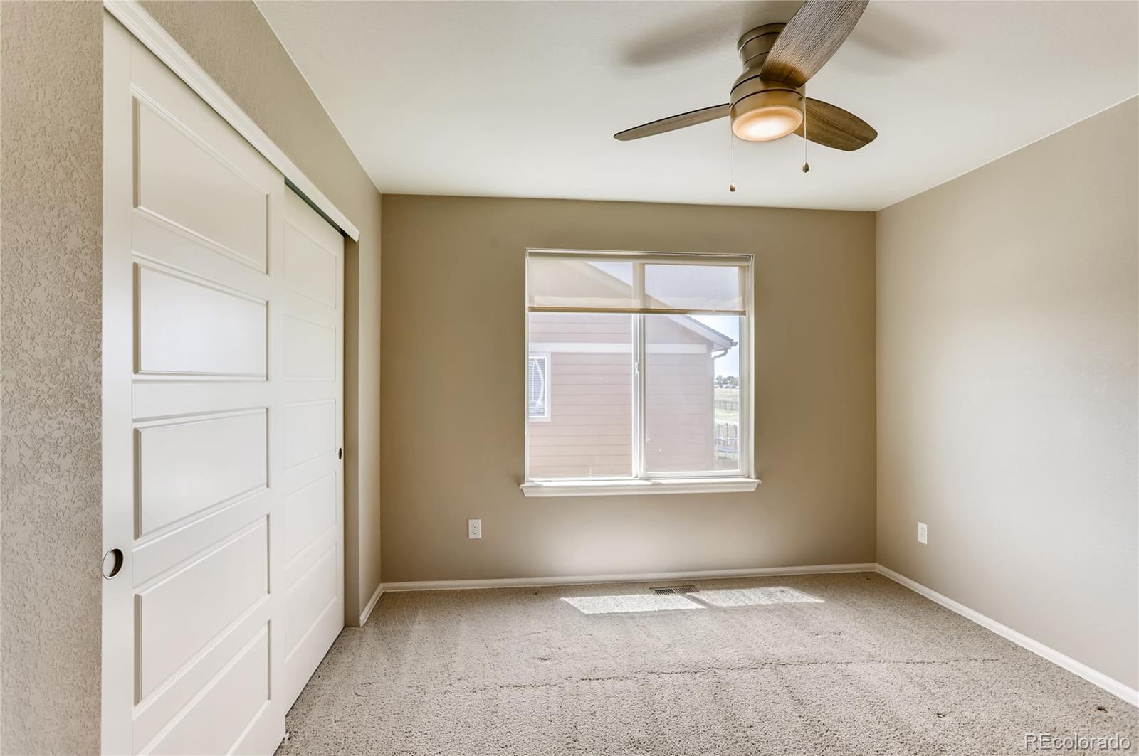 8627 Raspberry Drive Frederick, CO 80504 - Photo 24 of 33 an empty room with fan and windows