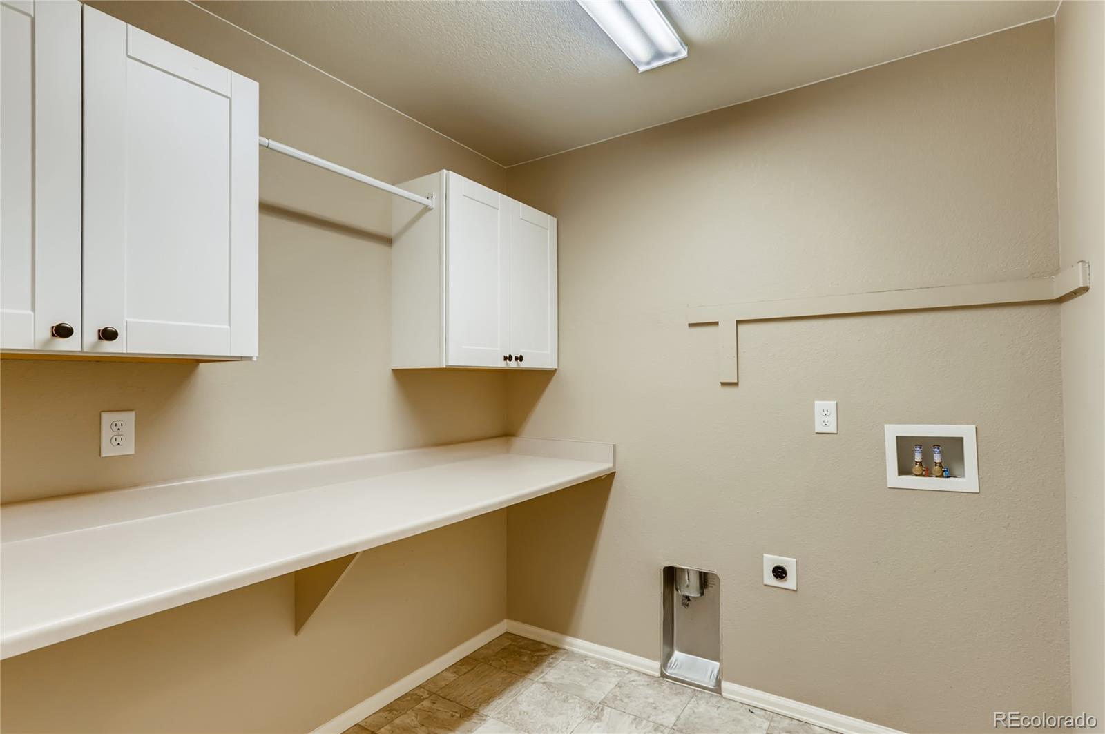 8627 Raspberry Drive Frederick, CO 80504 - Photo 27 of 33 a kitchen with a sink and a refrigerator