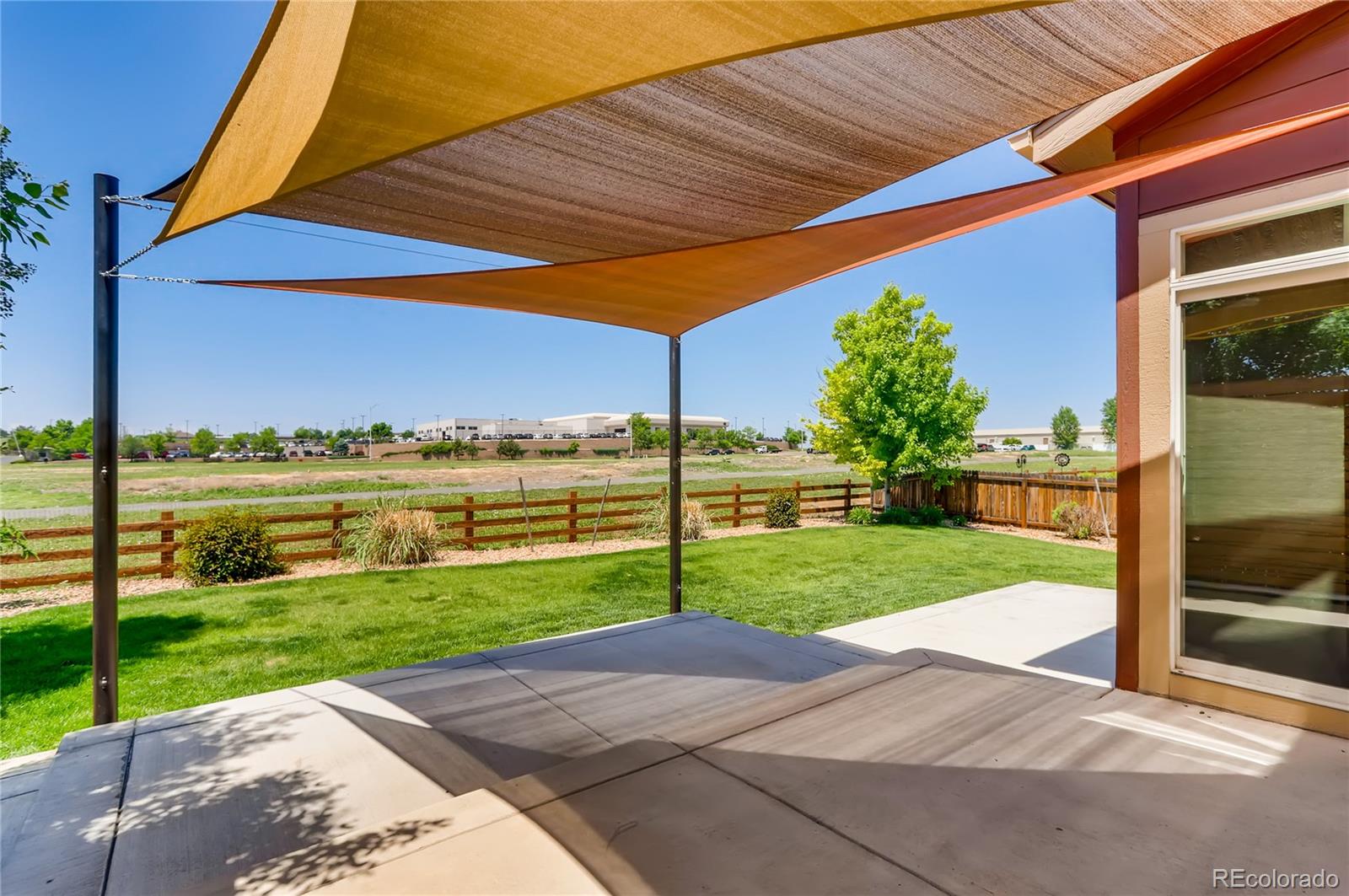 8627 Raspberry Drive Frederick, CO 80504 - Photo 31 of 33 a view of a backyard with table and chairs under an umbrella