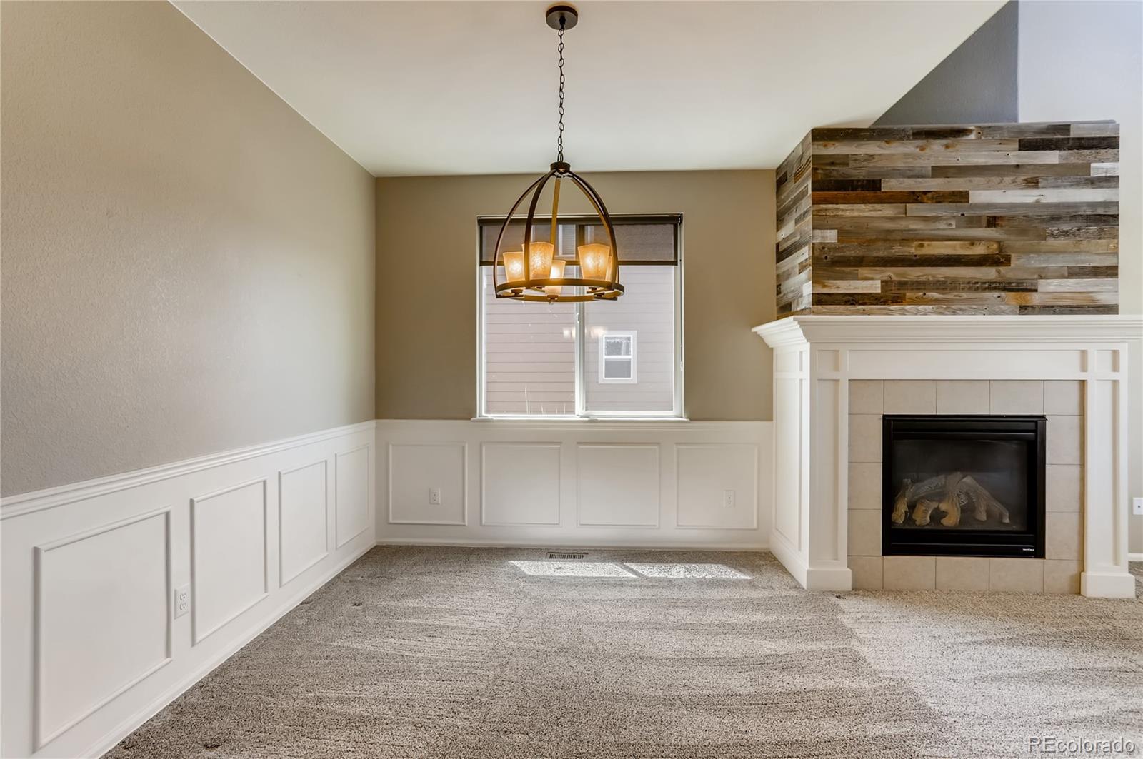 8627 Raspberry Drive Frederick, CO 80504 - Photo 9 of 33 a view of an empty room with a fireplace and a window