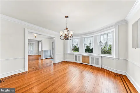 a view of a room with a window and wooden floor