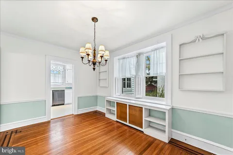 a kitchen with granite countertop white cabinets and white stainless steel appliances
