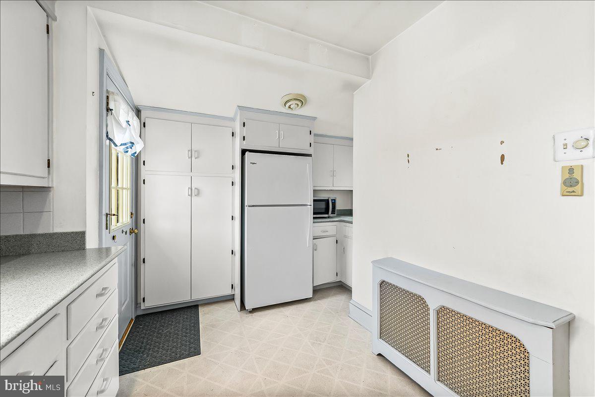 216 East Manoa Road Havertown, PA 19083 - Photo 17 of 37 a kitchen with white cabinets and refrigerator