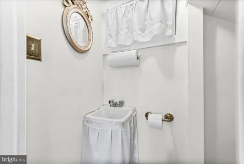 an empty room with windows and chandelier fan