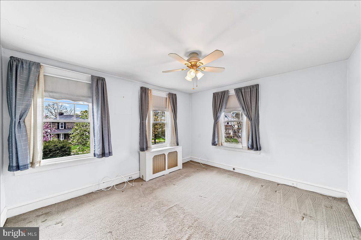 216 East Manoa Road Havertown, PA 19083 - Photo 20 of 37 an empty room with windows and chandelier fan
