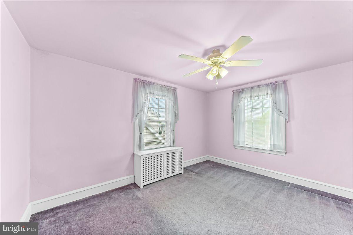 216 East Manoa Road Havertown, PA 19083 - Photo 22 of 37 an empty room with a window and a fan