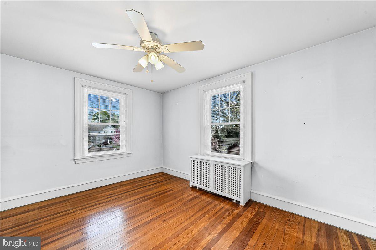 216 East Manoa Road Havertown, PA 19083 - Photo 23 of 37 a view of an empty room with wooden floor and a window