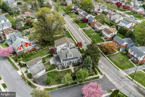 an aerial view of multiple houses with yard