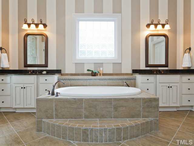 11300 Moonsprite Way Raleigh, NC 27614 - Photo 16 of 25 a bathroom with a sink a mirror and a vanity