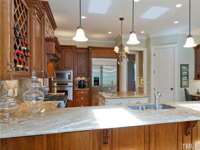 11300 Moonsprite Way Raleigh, NC 27614 - Photo 7 of 25 a view of a kitchen center island cabinets and chandelier