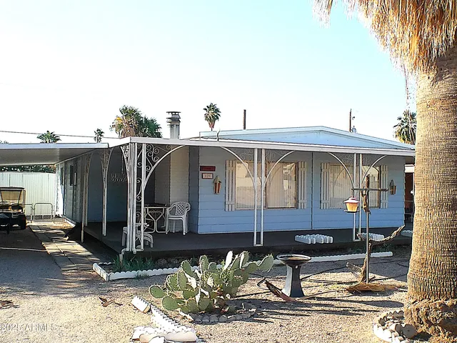 a front view of a house with sitting area