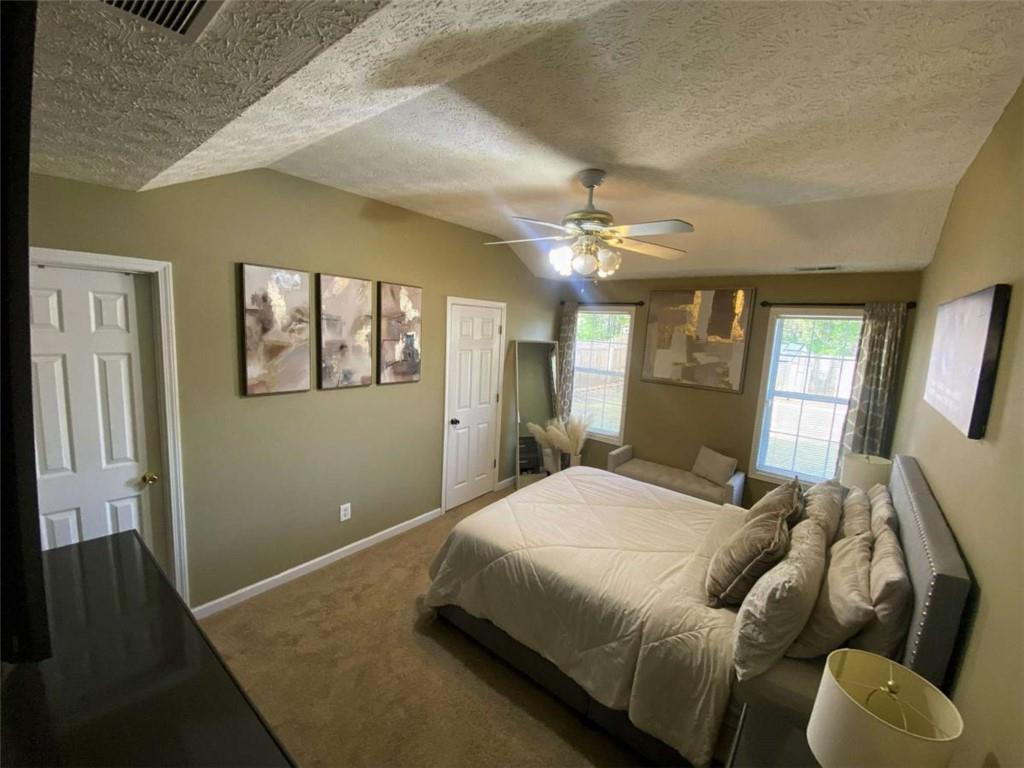188 Waters Edge Drive Locust Grove, GA 30248 - Photo 11 of 25 a spacious bedroom with a bed and window