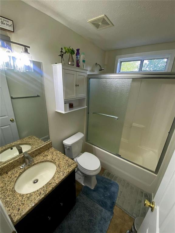 188 Waters Edge Drive Locust Grove, GA 30248 - Photo 15 of 25 a bathroom with a granite countertop sink toilet and shower