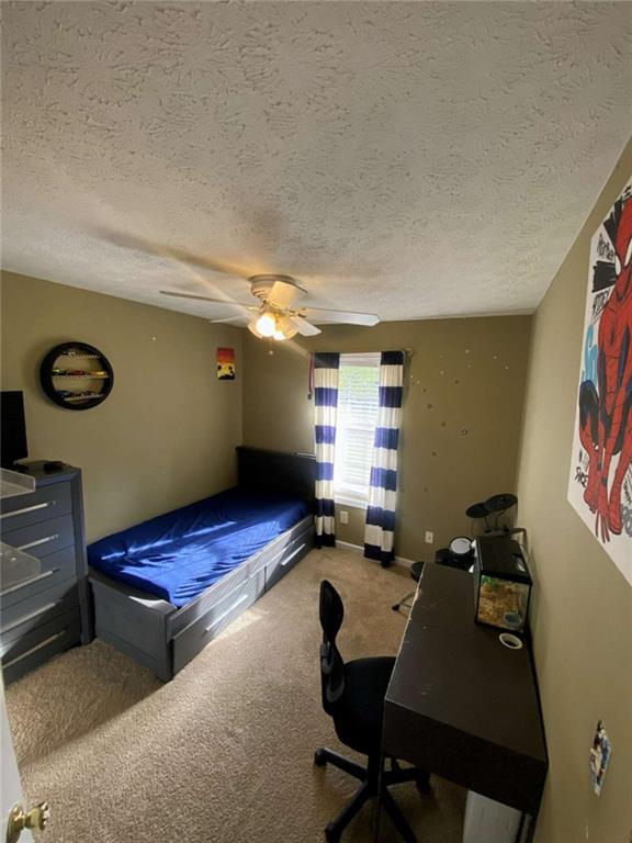 188 Waters Edge Drive Locust Grove, GA 30248 - Photo 16 of 25 a room with furniture gym equipment and a window