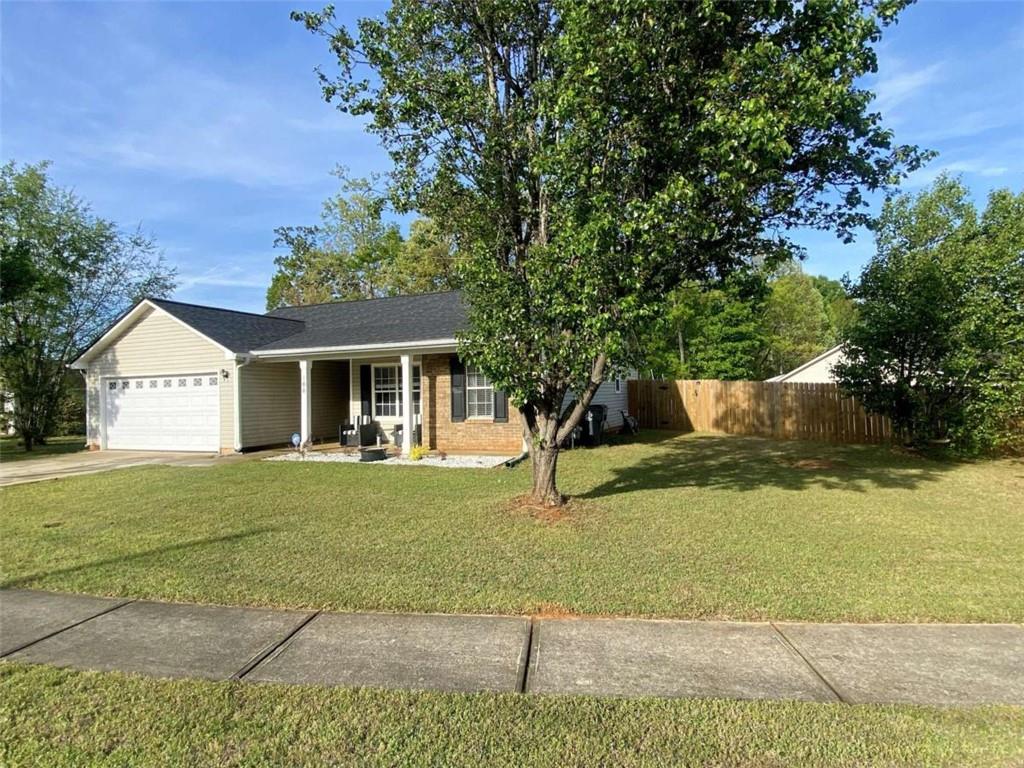 188 Waters Edge Drive Locust Grove, GA 30248 - Photo 2 of 25 a front view of a house with a yard and garage