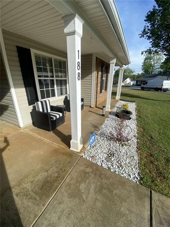 188 Waters Edge Drive Locust Grove, GA 30248 - Photo 4 of 25 a front view of a house with a garden and pathway