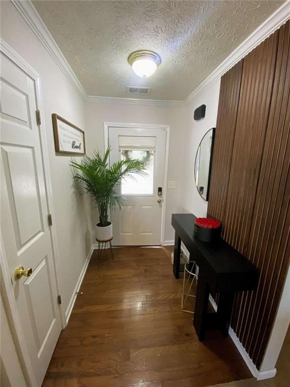 188 Waters Edge Drive Locust Grove, GA 30248 - Photo 5 of 25 a view of a hallway to a livingroom with furniture wooden floor and window