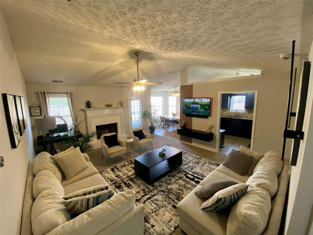 188 Waters Edge Drive Locust Grove, GA 30248 - Photo 6 of 25 a living room with furniture and a fireplace