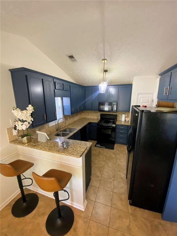188 Waters Edge Drive Locust Grove, GA 30248 - Photo 10 of 25 a kitchen with stainless steel appliances kitchen island granite countertop a sink refrigerator and cabinets