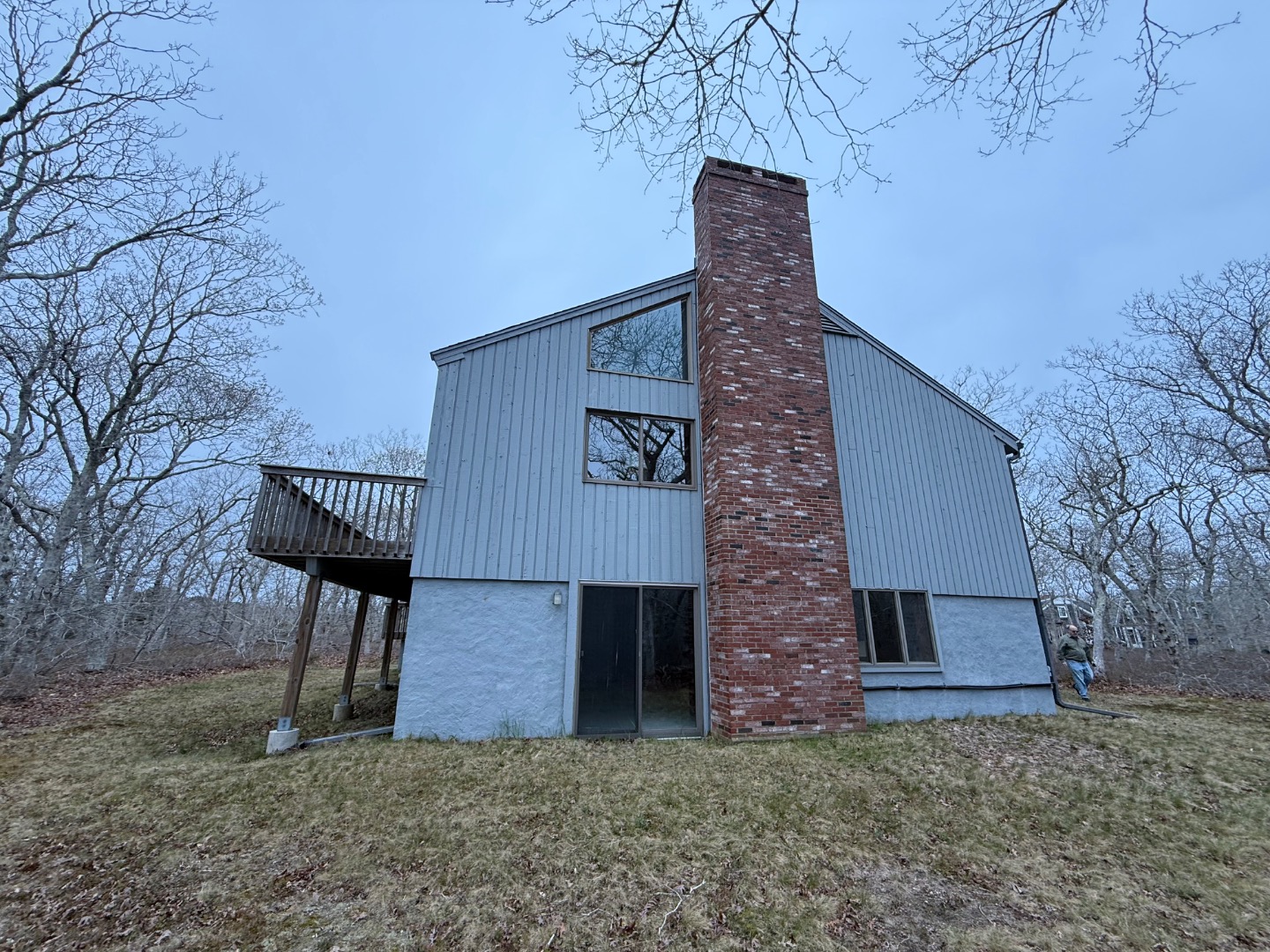 82 Oyster Pond Road Edgartown, MA 02539 - Photo 9 of 53 a brick building with a bench and large trees