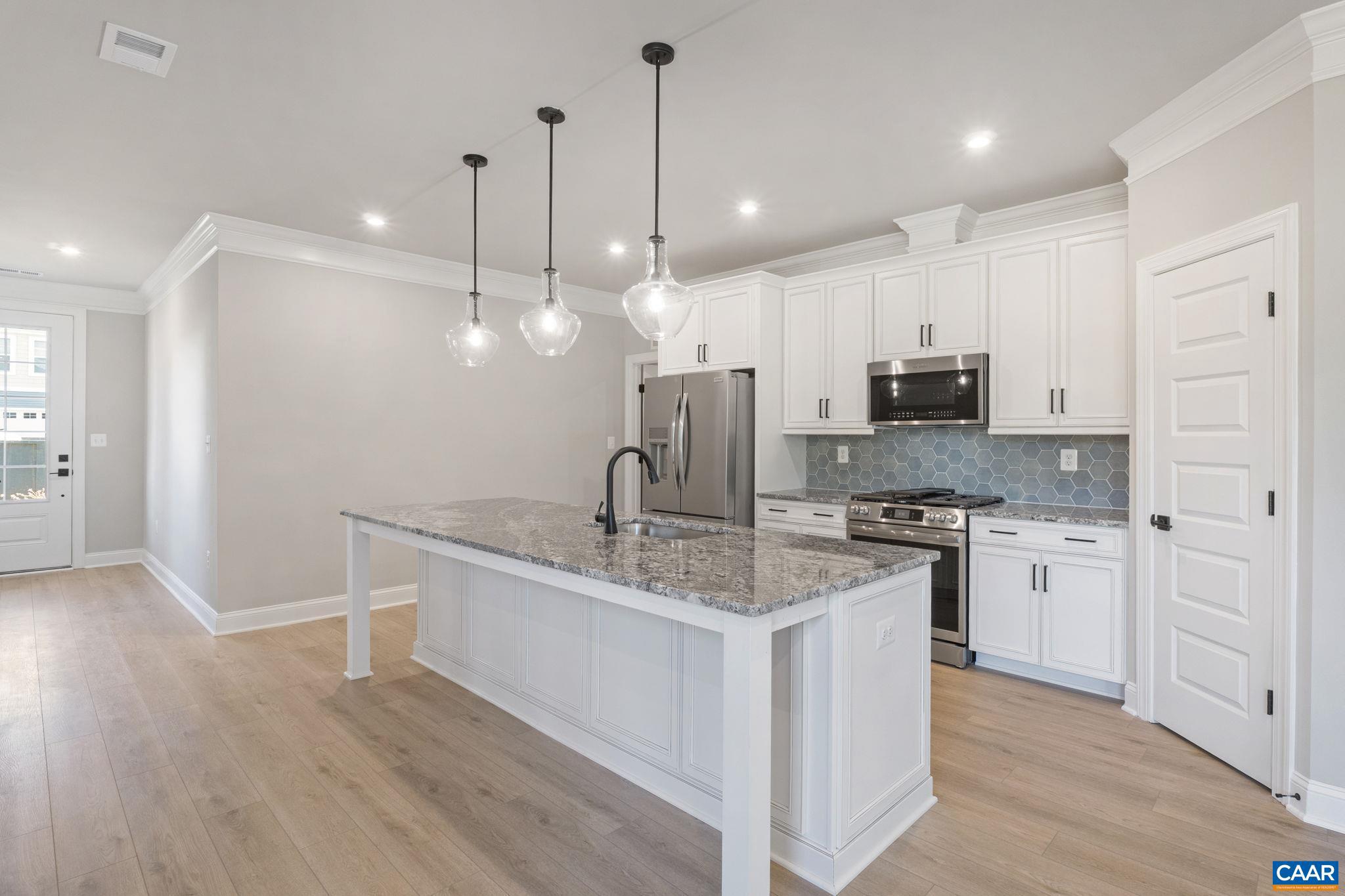 84 Springdale Road Waynesboro, VA 22980 - Photo 13 of 55 a kitchen with stainless steel appliances granite countertop a sink a stove a refrigerator and white cabinets with wooden floor