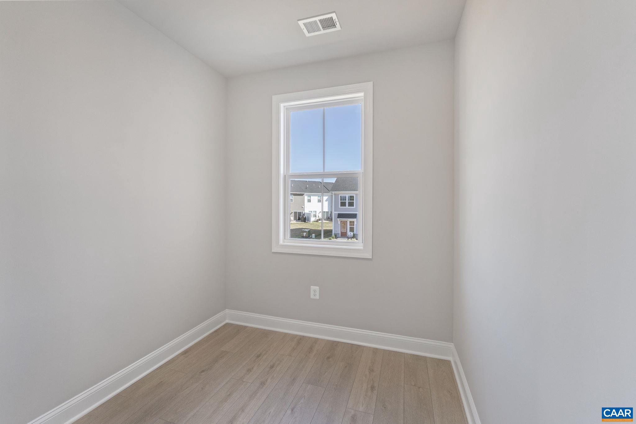 84 Springdale Road Waynesboro, VA 22980 - Photo 30 of 55 a view of an empty room with a window and wooden floor