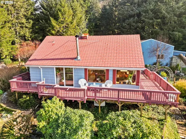 an aerial view of a house with a yard swimming pool and outdoor seating