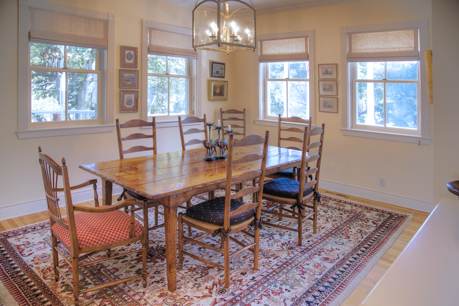 2898 Torito Road Summerland, CA 93108 - Photo 2 of 11 a dining room with wooden floor a chandelier a wooden table and chairs