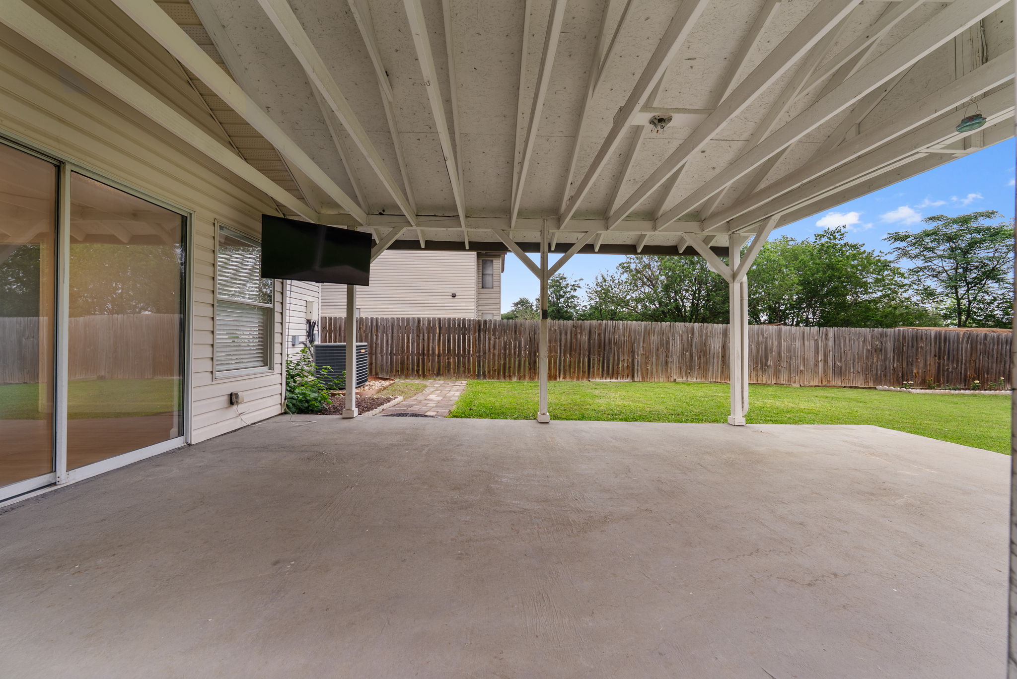 7327 Pusch Ridge Loop Austin, TX 78749 - Photo 22 of 26 A spacious covered patio overlooks the private, fenced yard, perfect for outdoor enjoyment.