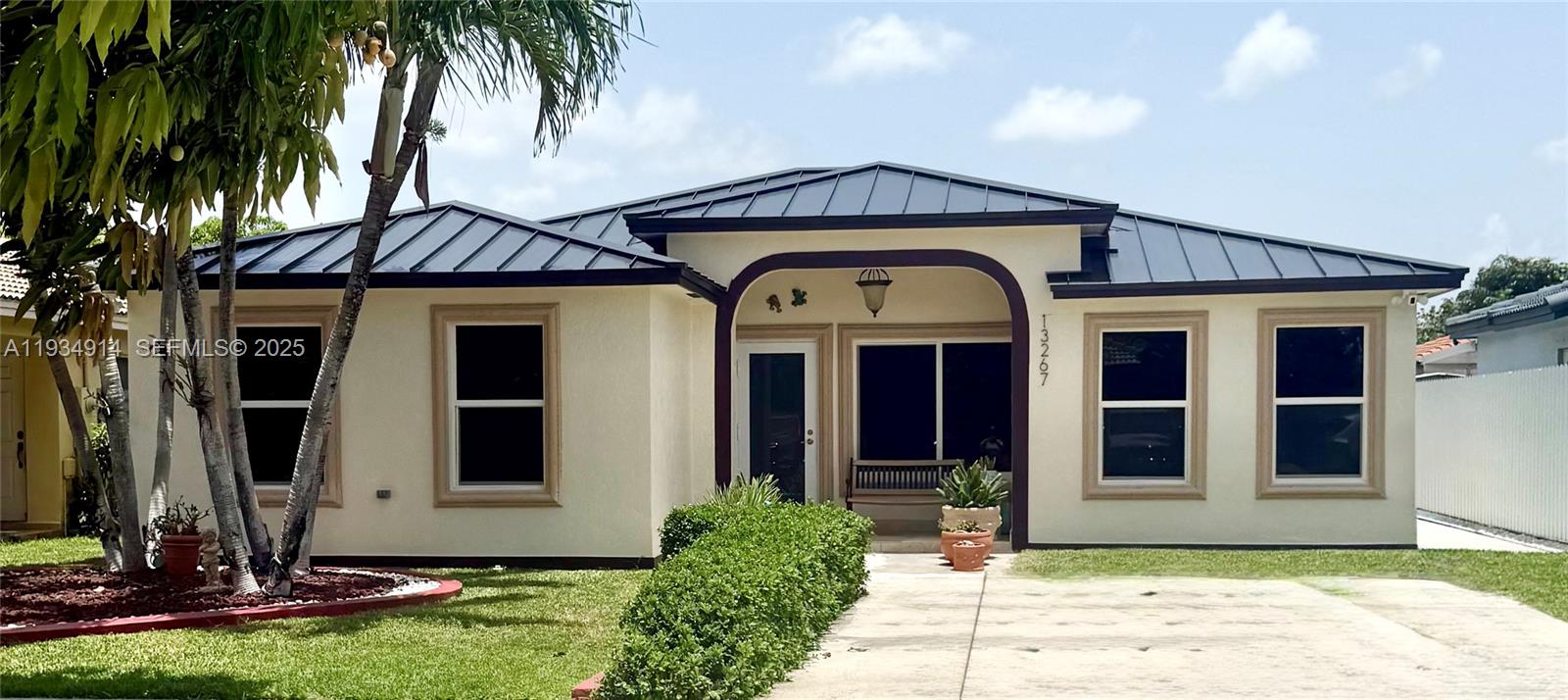 13267 Southwest 277th Terrace Homestead, FL 33032 - Photo 1 of 23 a front view of a house with a yard