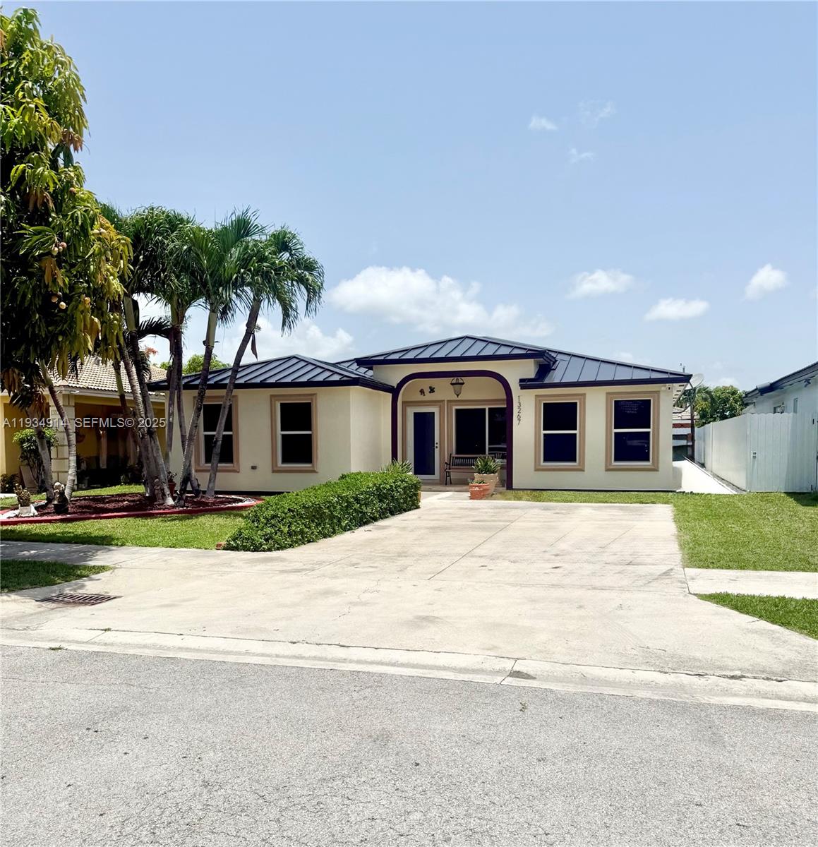 13267 Southwest 277th Terrace Homestead, FL 33032 - Photo 2 of 23 a front view of a house with a yard and garage