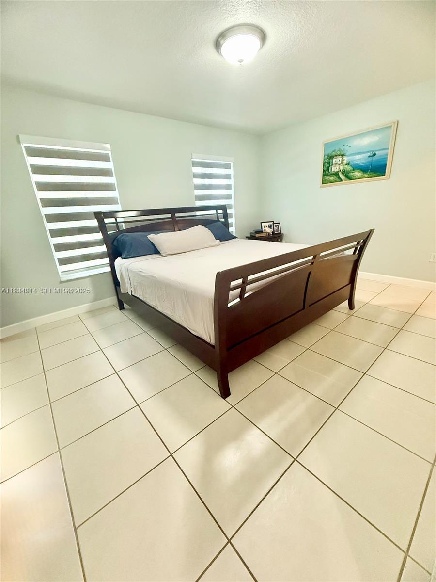 13267 Southwest 277th Terrace Homestead, FL 33032 - Photo 10 of 23 a bedroom with a bed and a shower