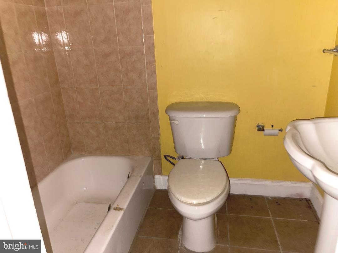 1609 Gales Street Northeast Washington, DC 20002 - Photo 14 of 29 a toilet sitting in a bathroom next to a sink