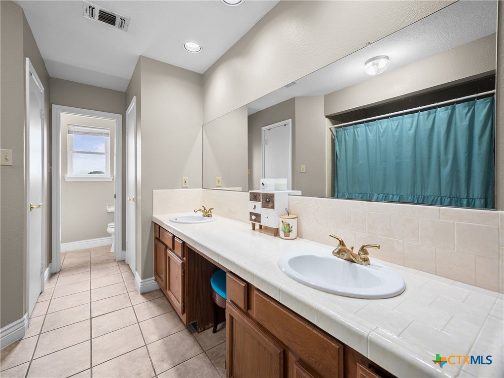 782 Santa Clara Loop Marion, TX 78124 - Photo 41 of 48 a bathroom with a double vanity sink and a mirror