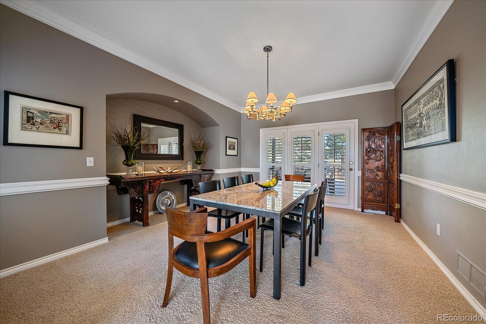 73 North Ranch Road Littleton, CO 80127 - Photo 12 of 49 a view of a dining room with furniture and a chandelier
