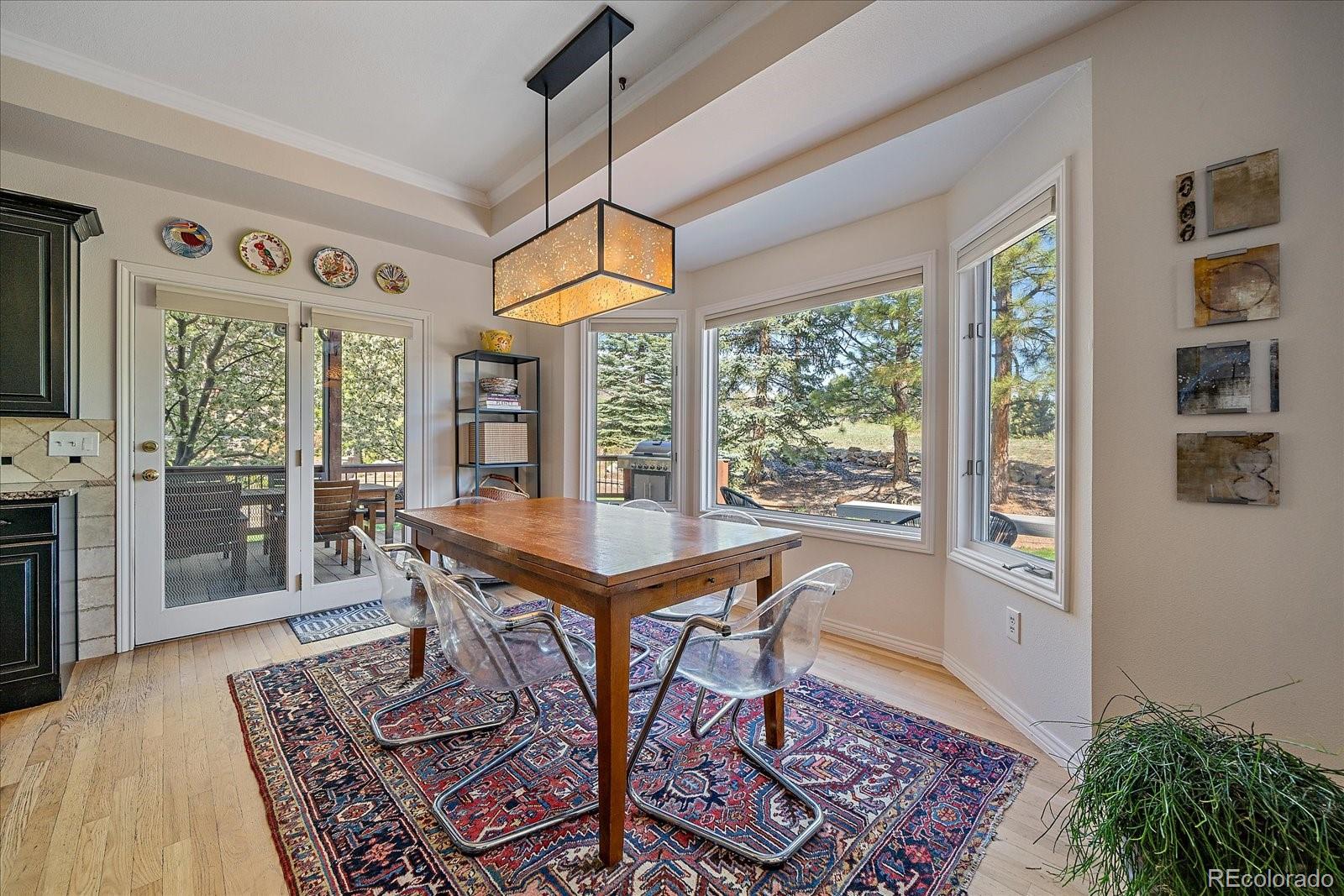 73 North Ranch Road Littleton, CO 80127 - Photo 16 of 49 a view of a dining room with furniture window and wooden floor