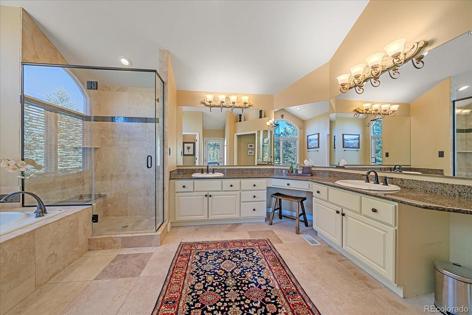 73 North Ranch Road Littleton, CO 80127 - Photo 20 of 49 a large bathroom with a double vanity sink a mirror and a bathtub