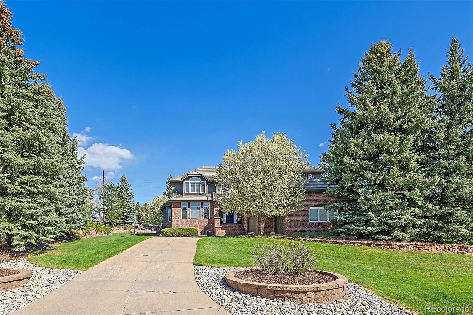 73 North Ranch Road Littleton, CO 80127 - Photo 2 of 49 a front view of a house with a yard