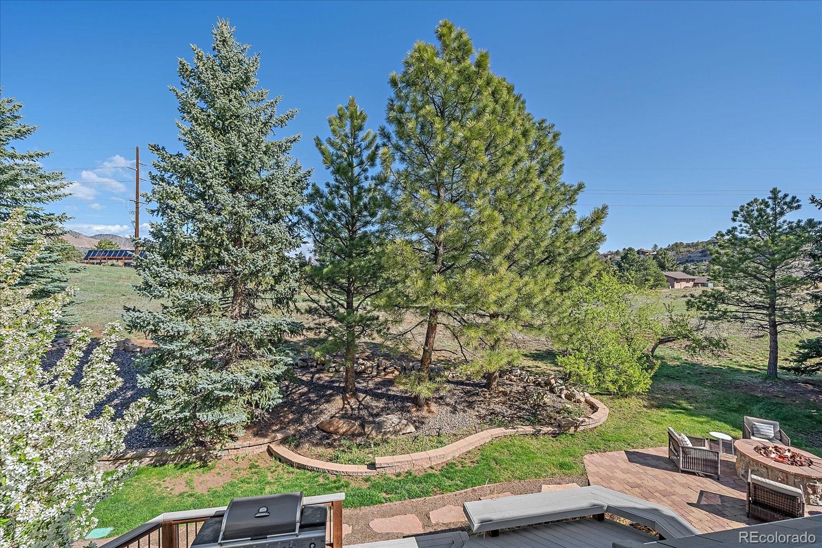 73 North Ranch Road Littleton, CO 80127 - Photo 22 of 49 a view of a yard with plants and outdoor seating