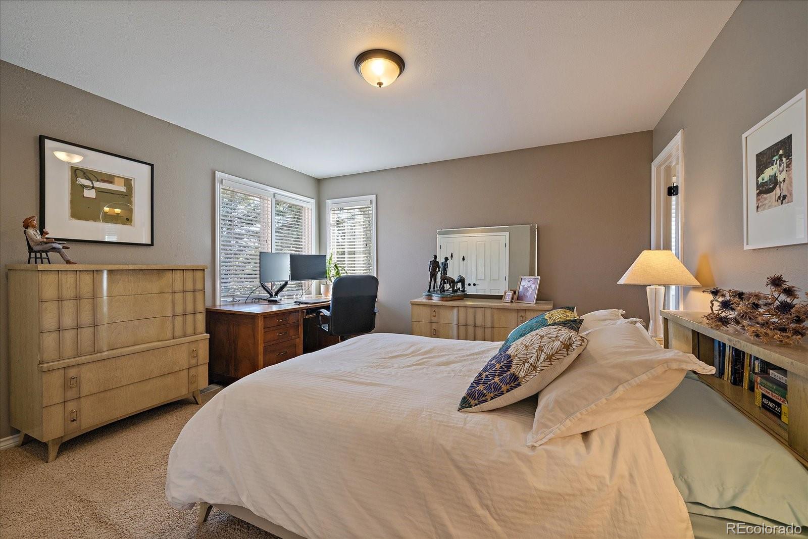 73 North Ranch Road Littleton, CO 80127 - Photo 23 of 49 a bed room with a bed and a lamp