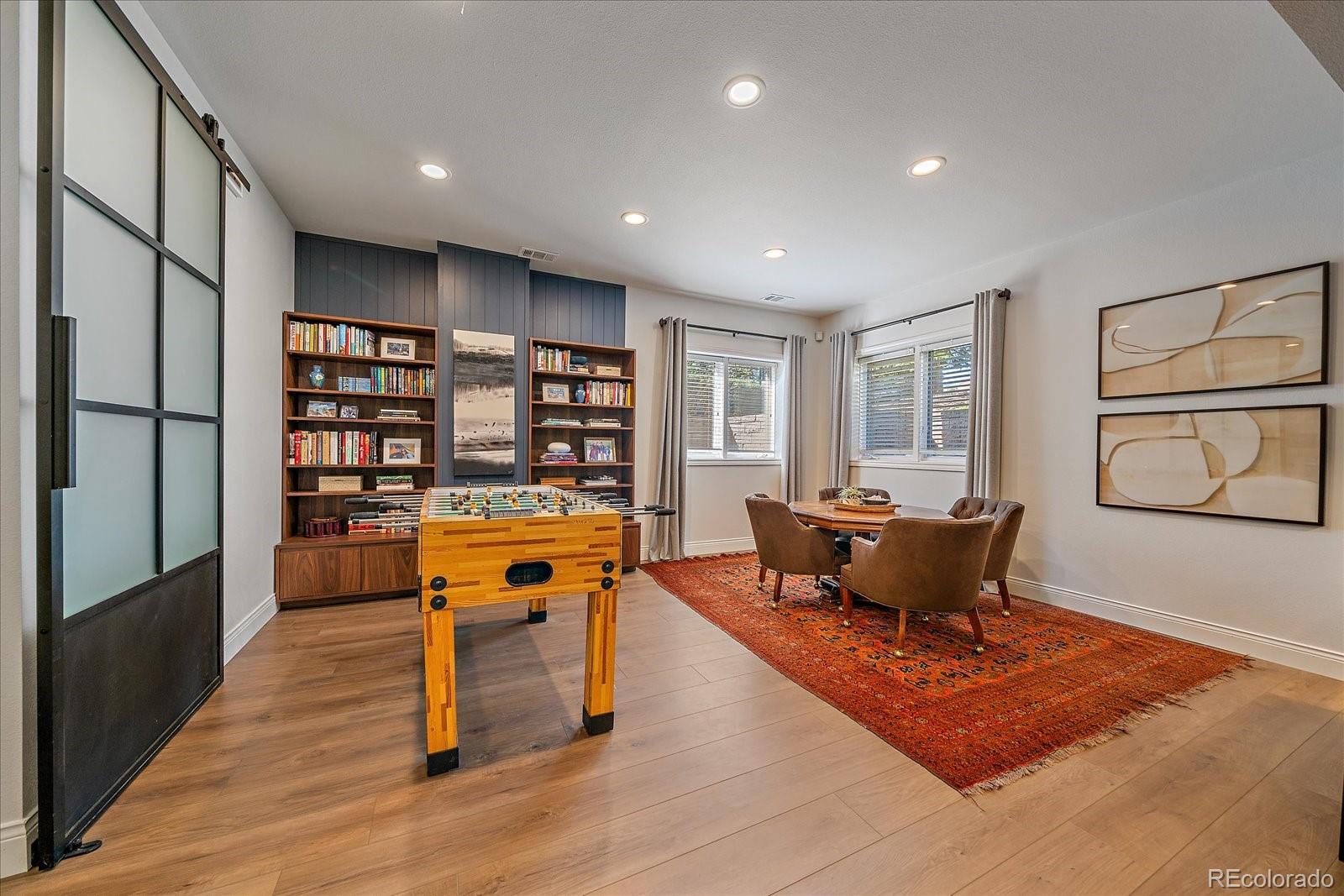73 North Ranch Road Littleton, CO 80127 - Photo 29 of 49 a living room with furniture a rug and a bookshelf