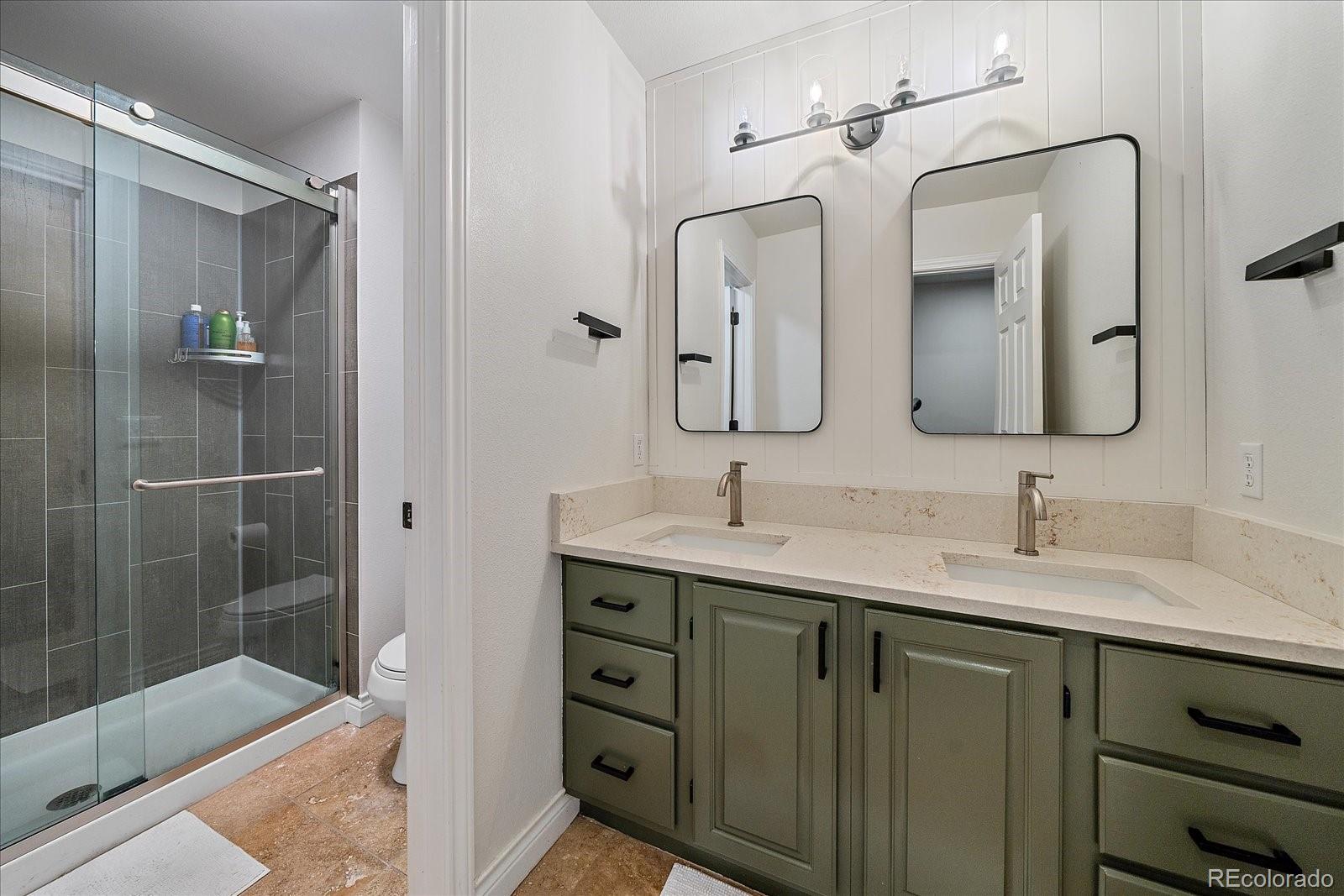 73 North Ranch Road Littleton, CO 80127 - Photo 34 of 49 a bathroom with a double vanity sink mirror and shower