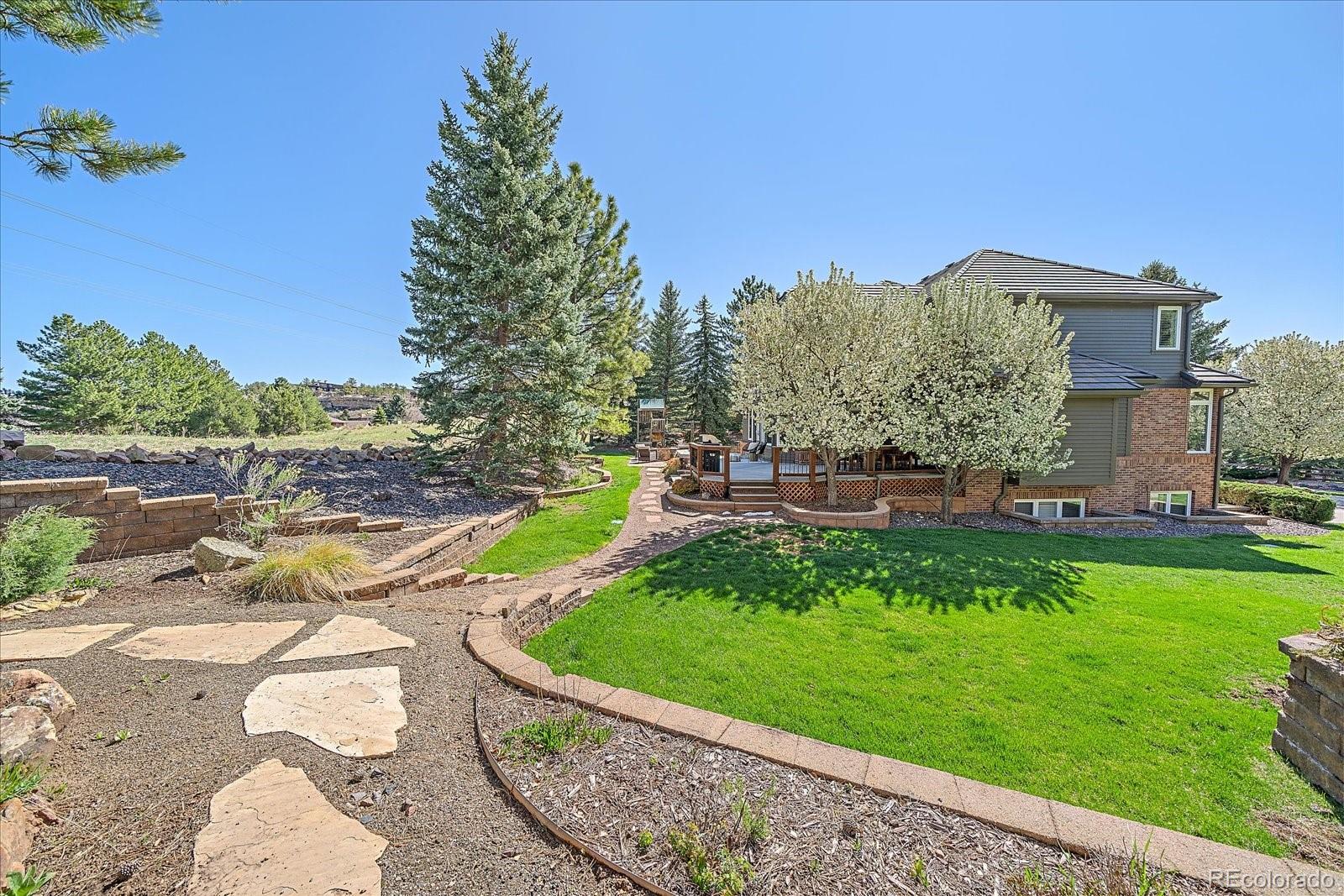73 North Ranch Road Littleton, CO 80127 - Photo 38 of 49 a view of a house with a yard