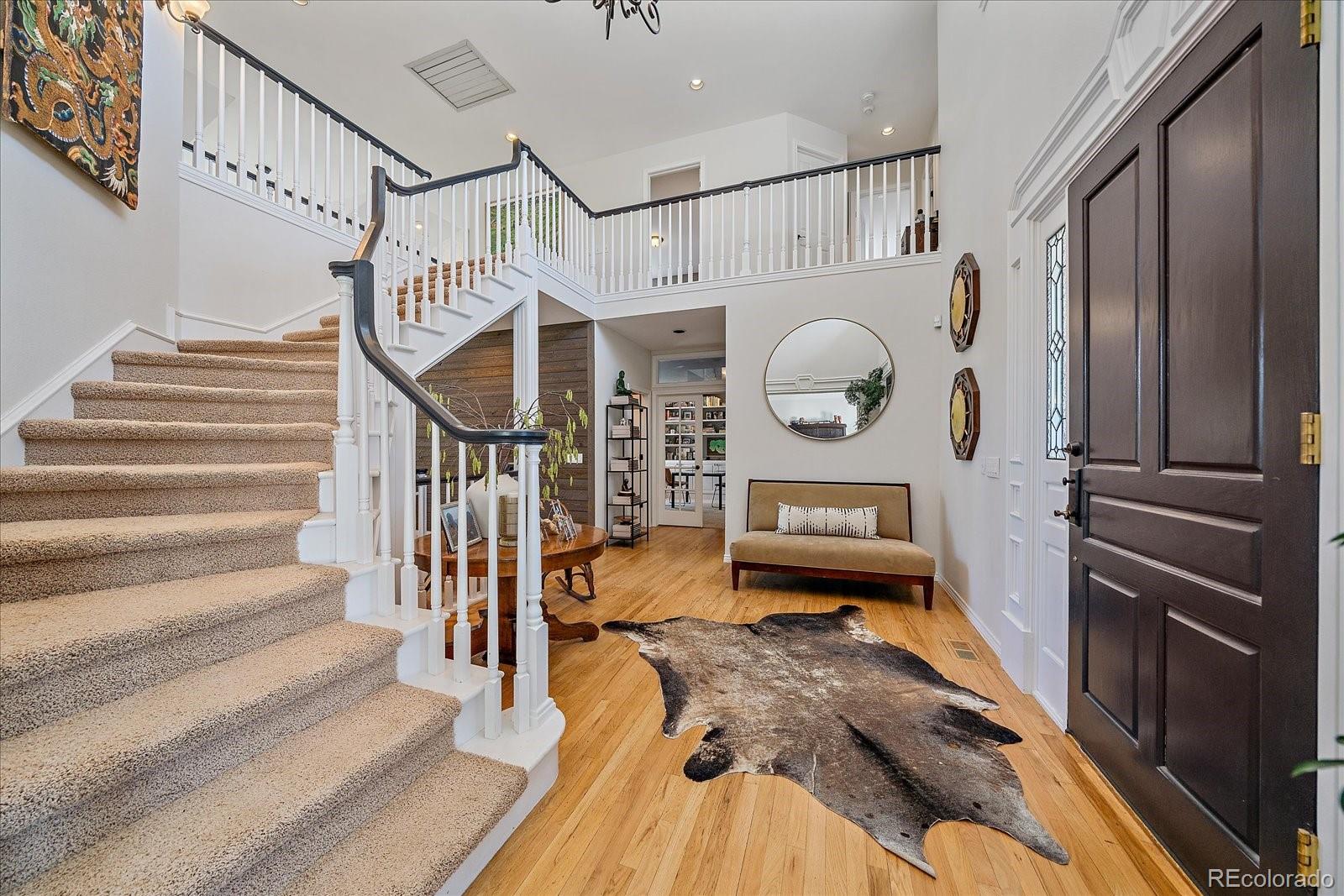 73 North Ranch Road Littleton, CO 80127 - Photo 4 of 49 a view of entryway and hall with wooden floor