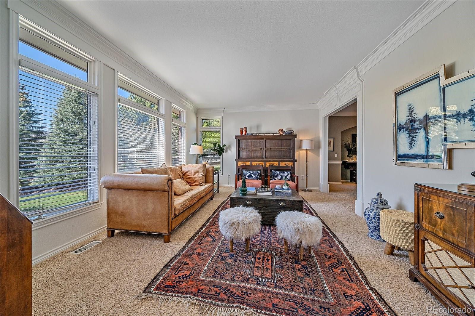 73 North Ranch Road Littleton, CO 80127 - Photo 5 of 49 a living room with furniture a flat screen tv and a window