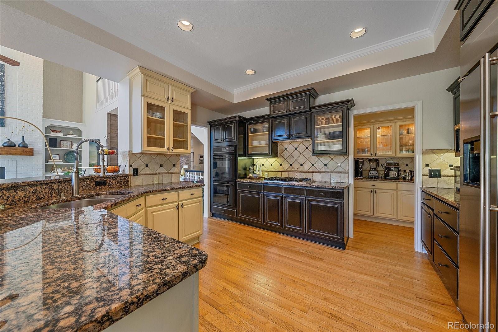 73 North Ranch Road Littleton, CO 80127 - Photo 10 of 49 a kitchen with stainless steel appliances granite countertop a stove a sink and a microwave